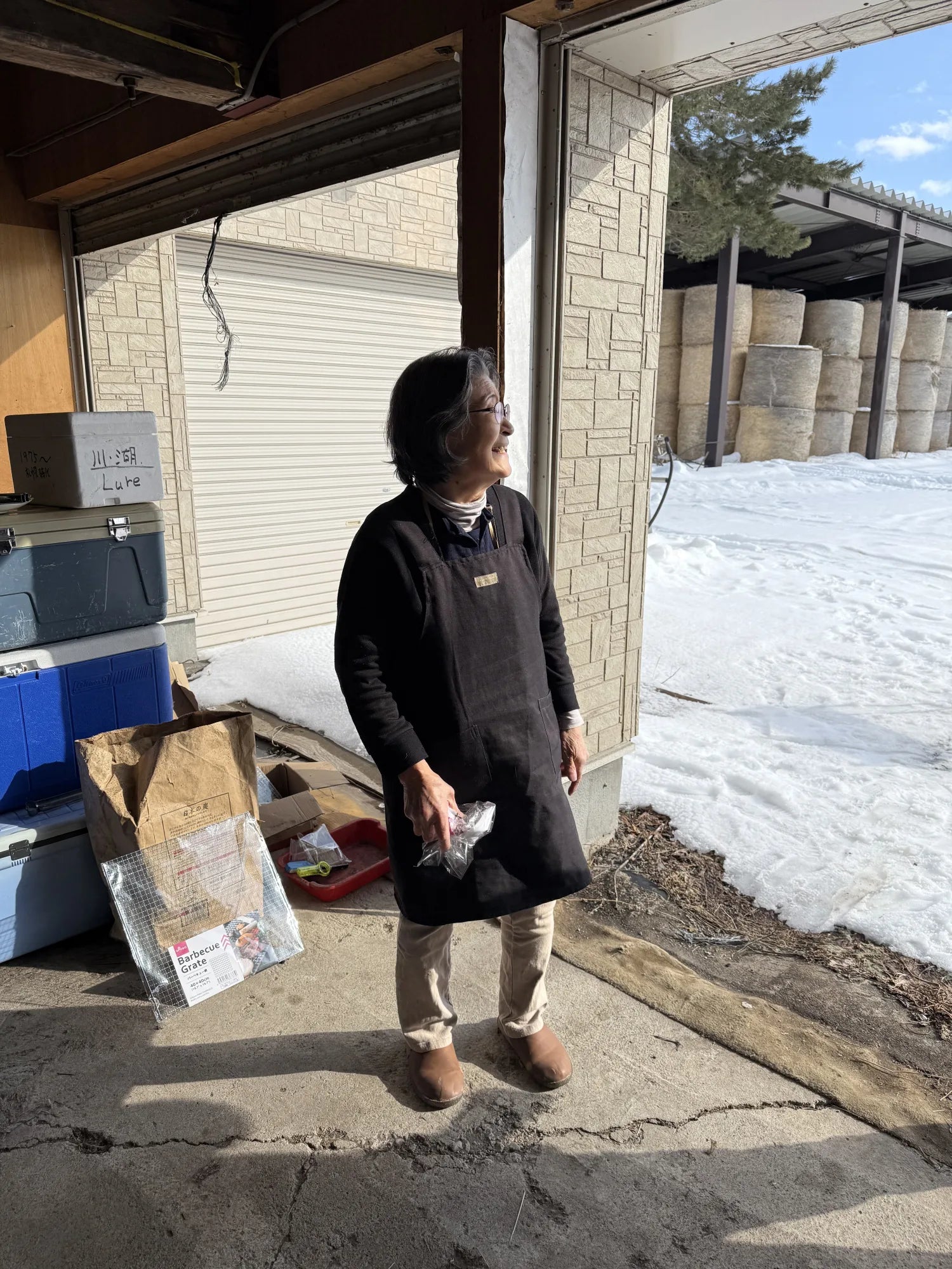 Tomoko-san, a friendly older Japanese woman, looking off to the right