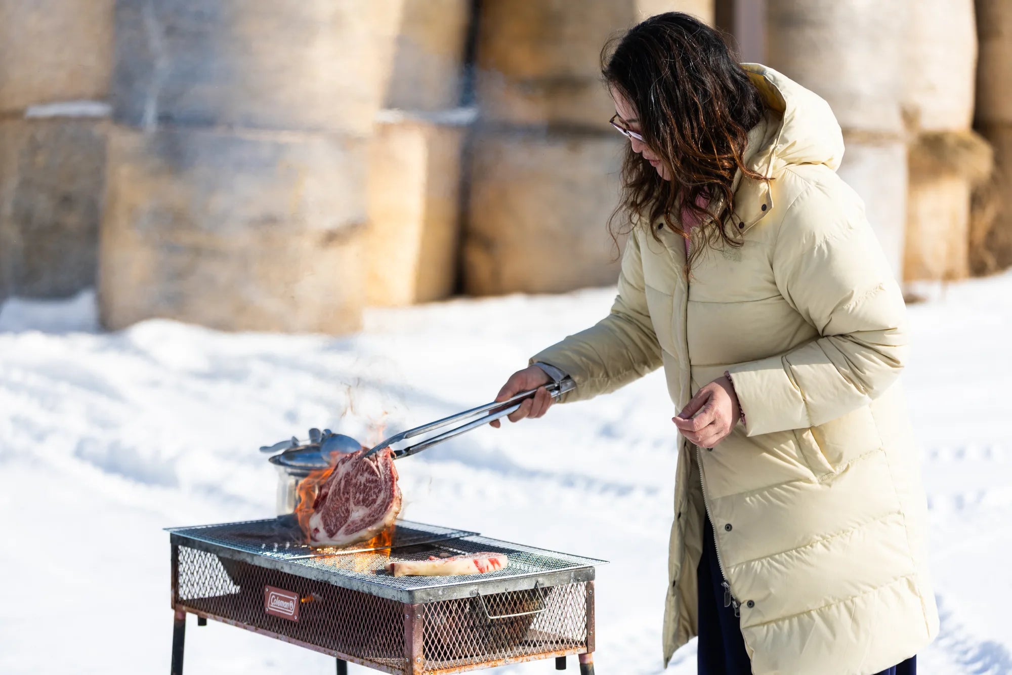 Ellie searing a Wagyu ribeye over open flame