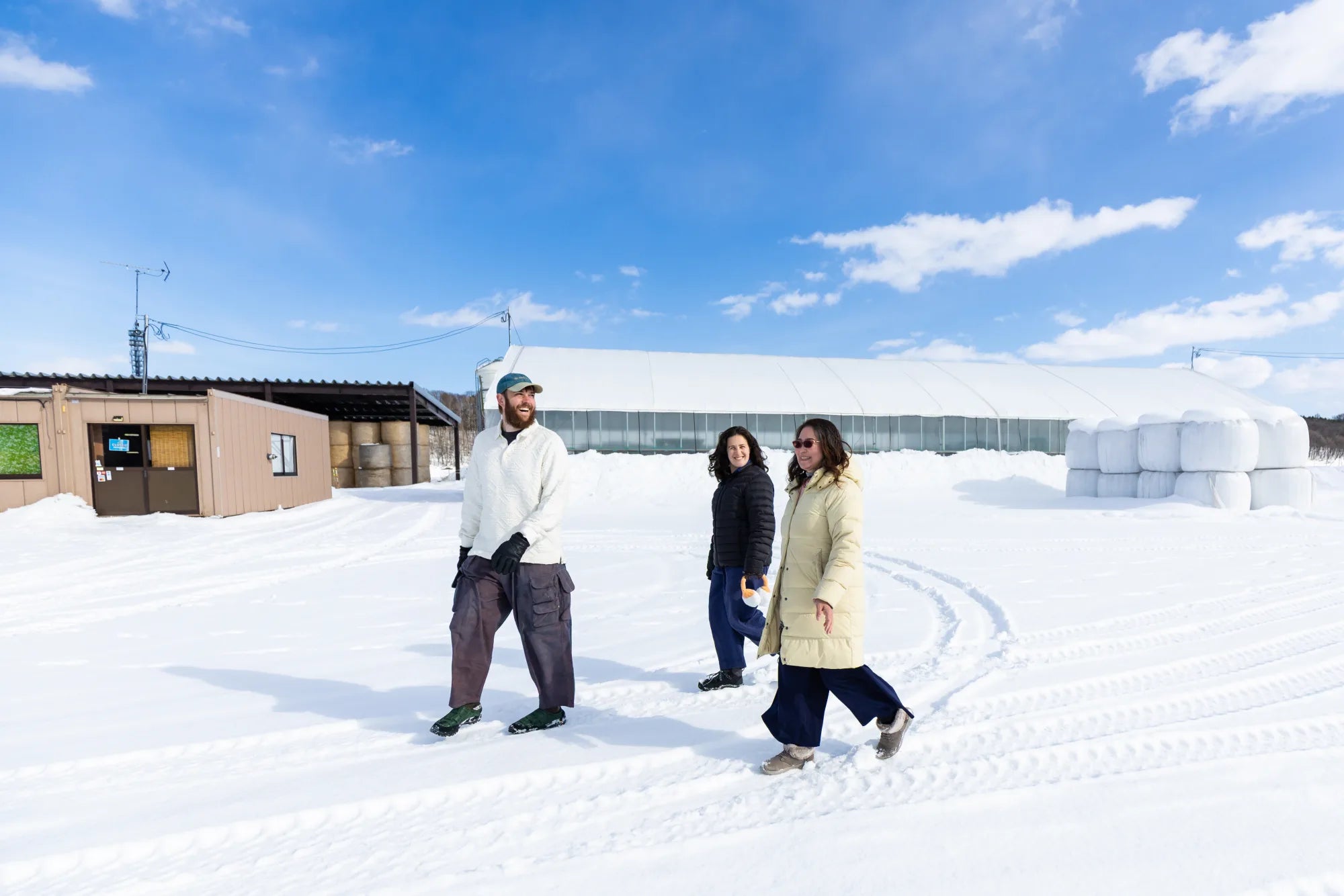 Matt, Rachel, and Ellie walking together at Takeda Farm